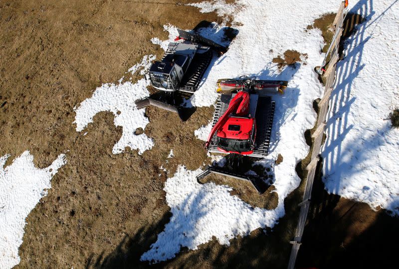 Snow groomers are pictured at the ski resort of The Mourtis, as the ski slopes are closed due to lack of snow in Boutx