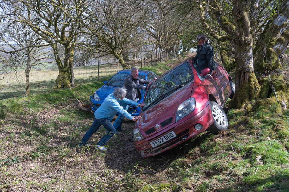 Richard Hammond sits in a crashed Renault while James May and Jeremy Clarkson push it in The Grand Tour Presents: Carnage A Trois. Photo: Amazon Prime Video (supplied).