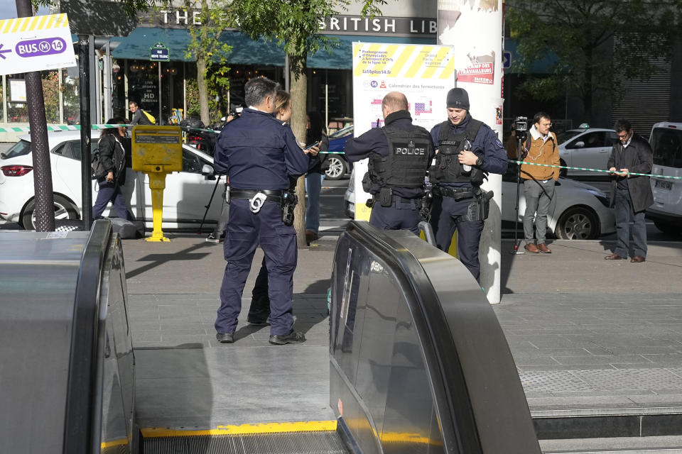 Police officers stand by a subway station after a woman allegedly made threatening remarks on a train, Tuesday, Oct. 31, 2023 in Paris. Paris police opened fire on a woman who allegedly made threatening remarks on a train, the latest security incident in the country that has been on heightened anti-terror alert since a fatal stabbing at a school blamed on an Islamic extremist.(AP Photo/Michel Euler)