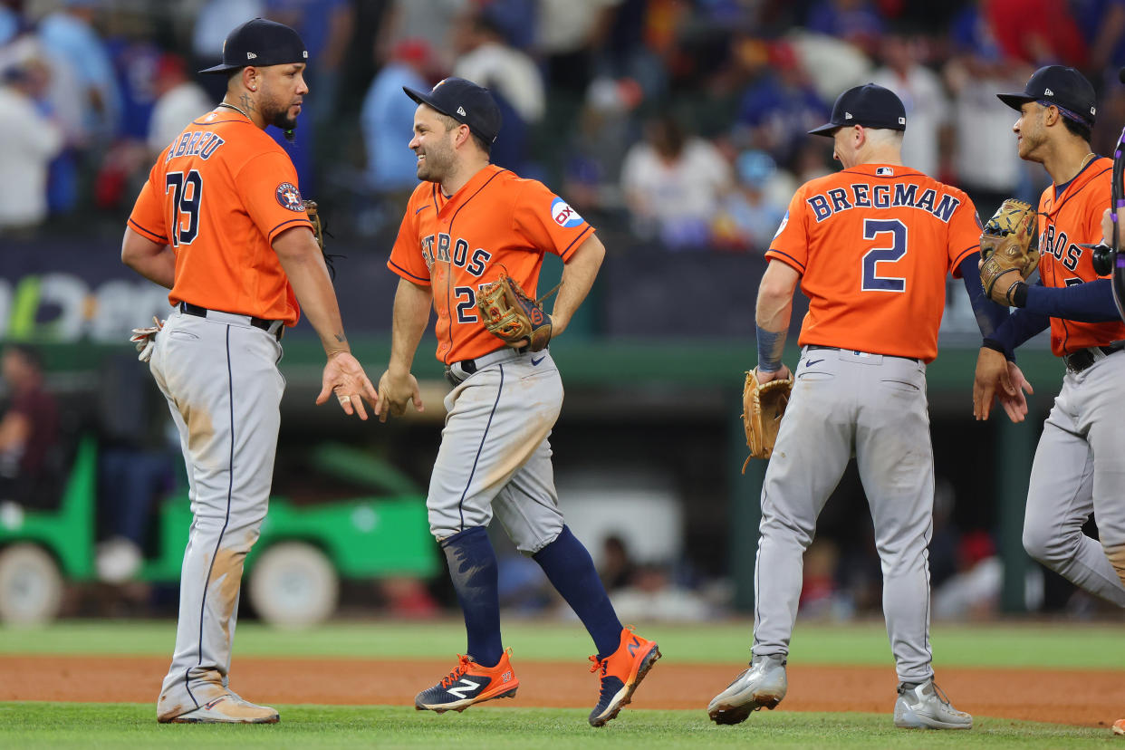 ARLINGTON, TEXAS - OCTOBER 19: José Abreu #79 and Jose Altuve #27 of the Houston Astros celebrate after beating the Texas Rangers 10-3 in Game Four of the Championship Series at Globe Life Field on October 19, 2023 in Arlington, Texas. (Photo by Stacy Revere/Getty Images)