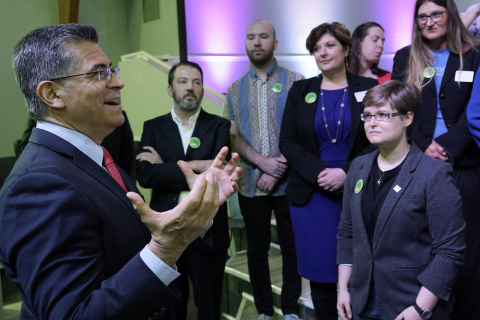 U.S. Department of Health and Human Services (HHS) Secretary Xavier Becerra, left, speaks to Oklahoma Medicaid advocates following a news conference Thursday, July 1, 2021, in Tulsa, Okla., as Oklahoma expands its Medicaid program. (AP Photo/Sue Ogrocki)