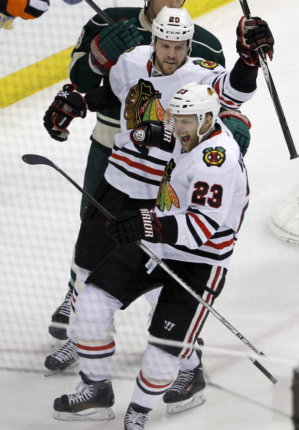 Chicago Blackhawks right wing Kris Versteeg (23) reacts in front of Blackhawks left wing Brandon Saad (20) after scoring on Minnesota Wild goalie Ilya Bryzgalov during the first period of Game 6 of an NHL hockey second-round playoff series in St. Paul, Minn., Tuesday, May 13, 2014. (AP Photo/Ann Heisenfelt)