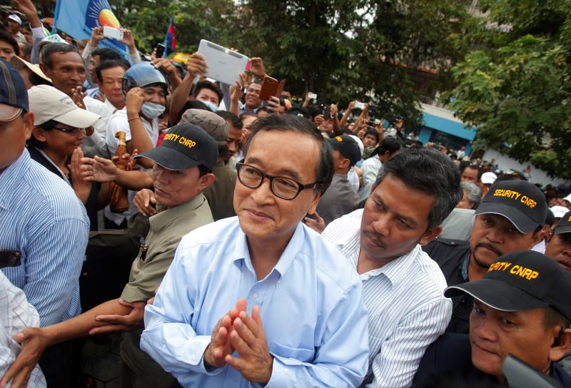 FILE PHOTO: Sam Rainsy, president of the opposition Cambodia National Rescue Party (CNRP), greets supporters at the Freedom Park in Phnom Penh