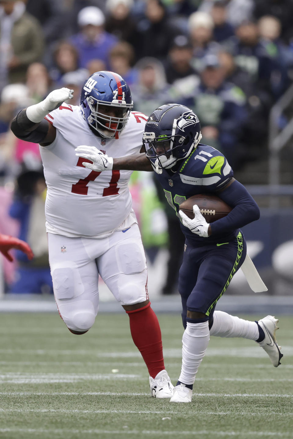 Seattle Seahawks wide receiver Marquise Goodwin (11) runs against New York Giants defensive tackle Justin Ellis (71) during the first half of an NFL football game in Seattle, Sunday, Oct. 30, 2022. (AP Photo/John Froschauer)