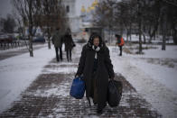 CORRECTS DAY OF THE WEEK A woman walks in central Kyiv, Ukraine, Tuesday Jan. 31, 2023. (AP Photo/Daniel Cole)
