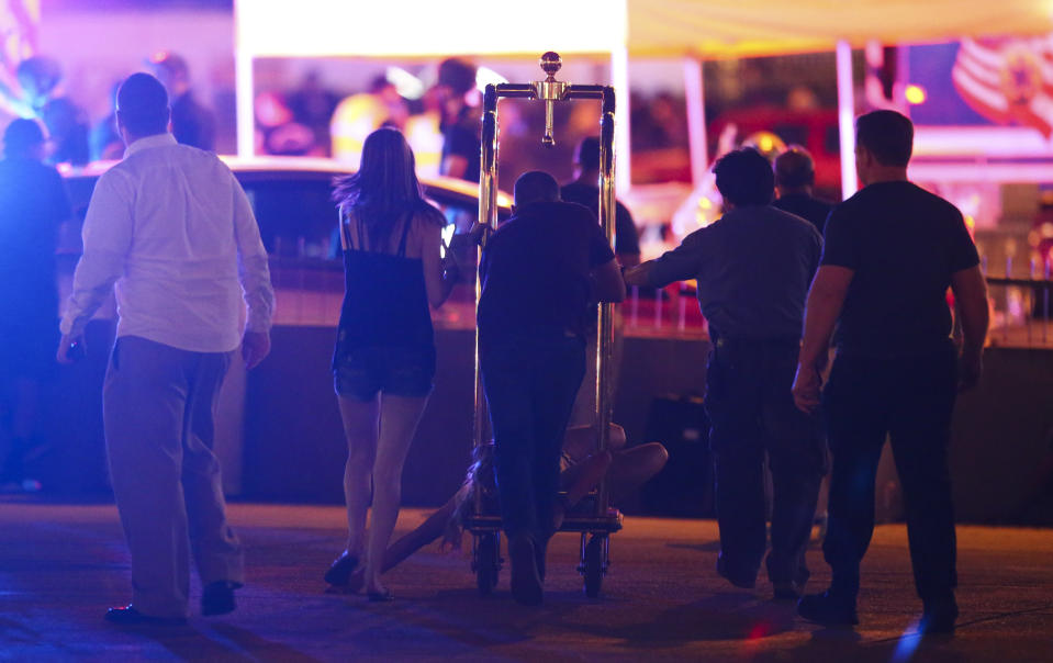 <p>A wounded woman is moved outside the Tropicana during an active shooter situation on the Las Vegas Strip in Las Vegas Sunday, Oct. 1, 2017. (Photo: Chase Stevens/Las Vegas Review-Journal via AP) </p>