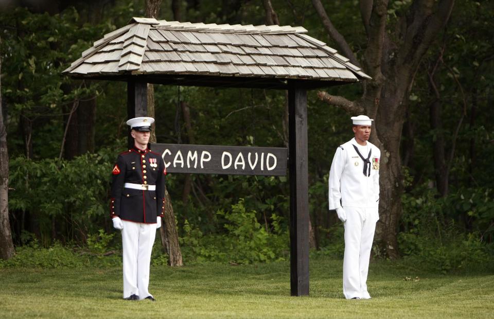 FILE - In this June 26, 2008 file photo, members of an honor guard stand at attention at Camp David, Md. Thursday, June 26, 2008. President Barack Obama will play host this weekend to an extraordinary confluence of international summitry, with world leaders scuttling from the Maryland mountains to downtown Chicago as they grapple for fixes to Europe's mounting economic woes and solidify plans for winding down the decade-long war in Afghanistan. (AP Photo/Pablo Martinez Monsivais, File)