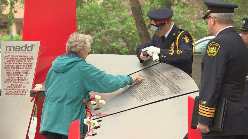 Names of victims of impaired driving appear on the monument, shaped like a large sundial.