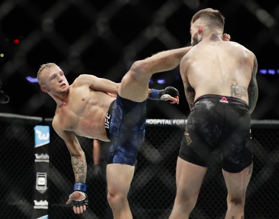 FILE - In this Nov. 4, 2017, file photo, T.J. Dillashaw, left, kicks Cody Garbrandt during a bantamweight title mixed martial arts bout at UFC 217 in New York. ESPN will raise the curtain on the octagon Saturday, Jan. 19, 2019, and air the first card of a $1.5 billion, five-year deal that will plaster UFC all over the sports network's various platforms. (AP Photo/Frank Franklin II, File)