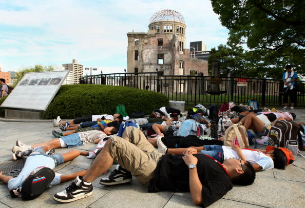 Japanese people stage a die-in protest in front of the Hiroshima Peace Memorial, commonly called the Atomic Bomb Dome at the Hiroshima Peace Memorial Park on August 6, 2012 in Hiroshima. Japan. Tomorrow marks the 67th anniversary of the first atomic bomb that was dropped on Hiroshima by the United States on August 6, 1945, killing an estimated 70,000 people instantly with many thousands more dying over the following years from the effects of radiation. Three days later another atomic bomb was dropped on Nagasaki, ending World War II. (Photo by Buddhika Weerasinghe/Getty Images)