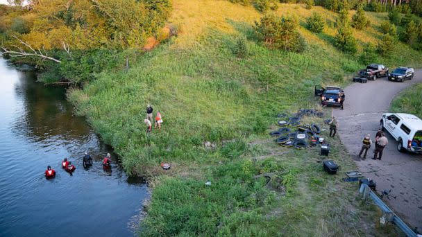 PHOTO: Water Recovery authorities comb the Apple River with metal detectors after five people were stabbed while tubing down the river in Somerset, Wis., July 30, 2022. (Alex Kormann/AP)