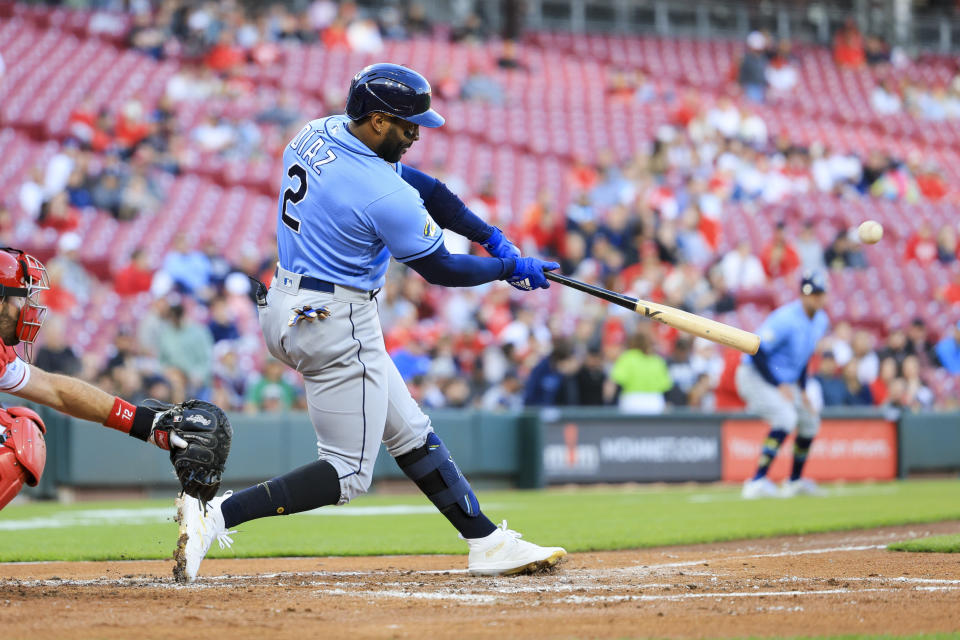 Tampa Bay Rays' Yandy Diaz hits a three-run home run against the Cincinnati Reds during the second inning of a baseball game Tuesday, April 18, 2023, in Cincinnati. (AP Photo/Aaron Doster)