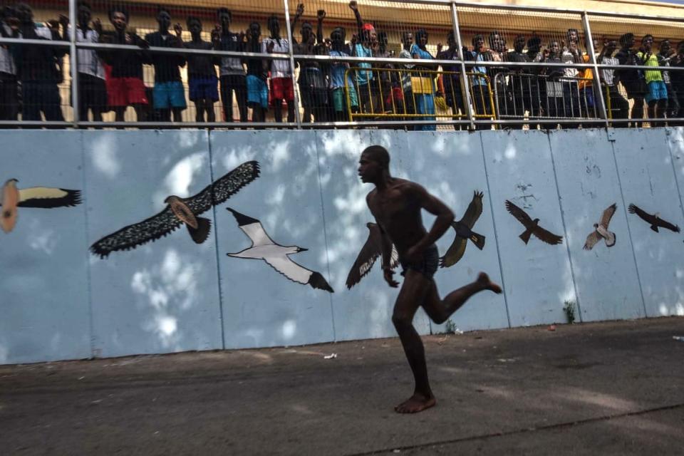 <div class="inline-image__caption"><p>A man runs after over 100 migrants forced their way into the Spanish territory of Ceuta on August 22, 2018. - The migrants made their way into Ceuta after storming a barbed-wire border fence with Morocco and attacking police with caustic quicklime, a local official said. </p></div> <div class="inline-image__credit">JOAQUIN SANCHEZ/GETTY</div>