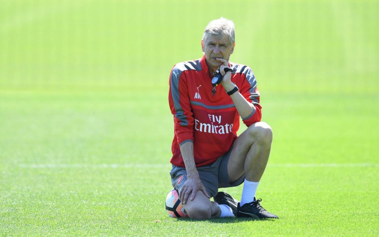 Arsene Wenger watches on during Friday's training session - Arsenal FC