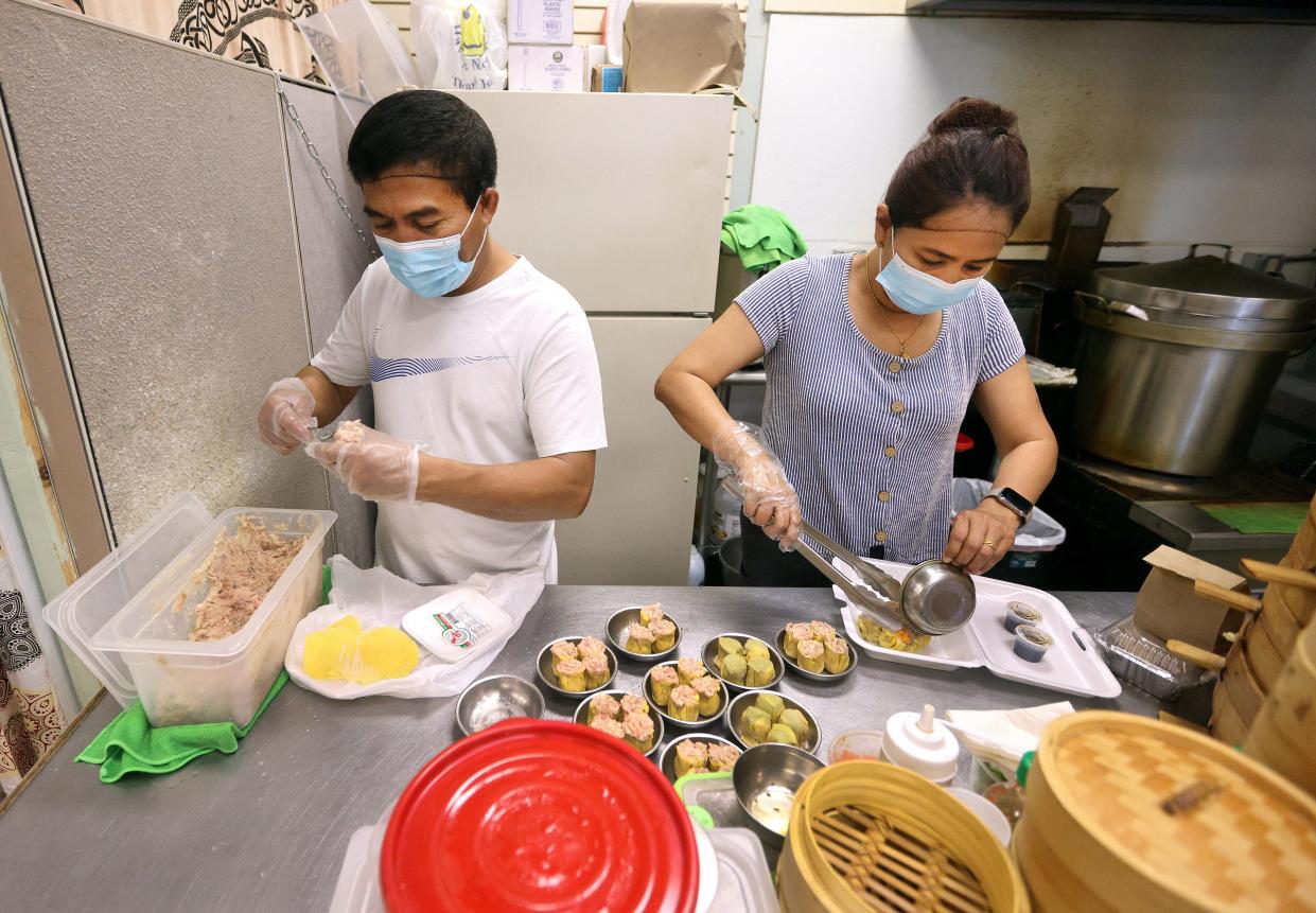 Maung Maung and his wife, Than Than, who came from Myanmar, make dim sum at their restaurant, 007 Chinese Food, in the West Side Bazaar in Buffalo, N.Y.