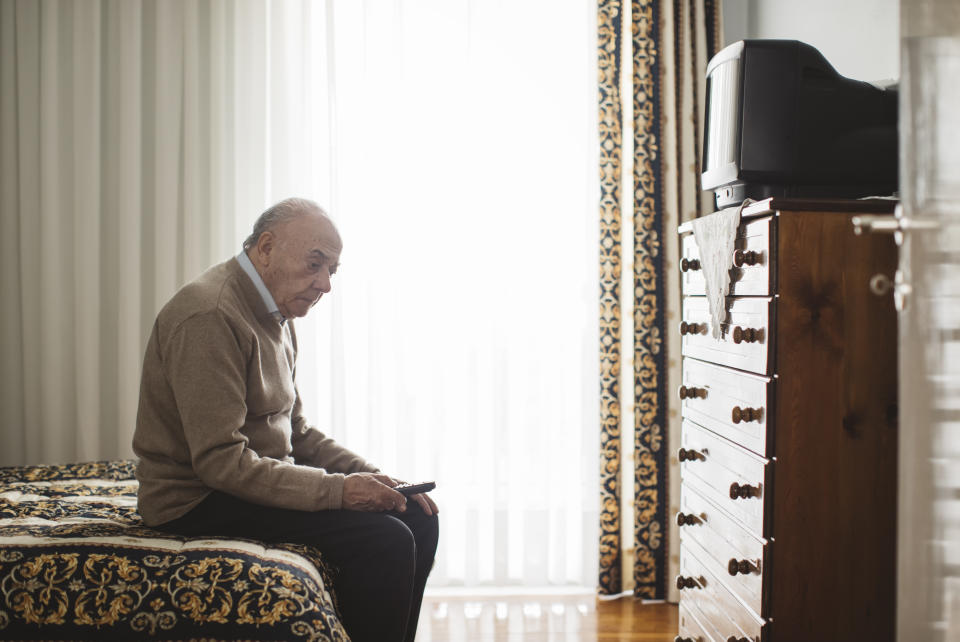 Senior man in front of a television