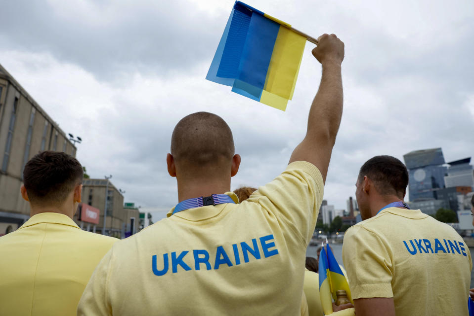 Ukrainian athletes on a boat before the opening ceremony of the 2024 Summer Olympics on the River Seine in Paris, France.  / Credit: Clodagh Kilcoyne / AP