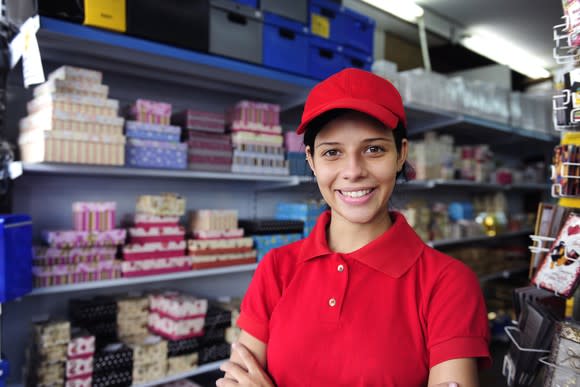 A teen in uniform in a retail store