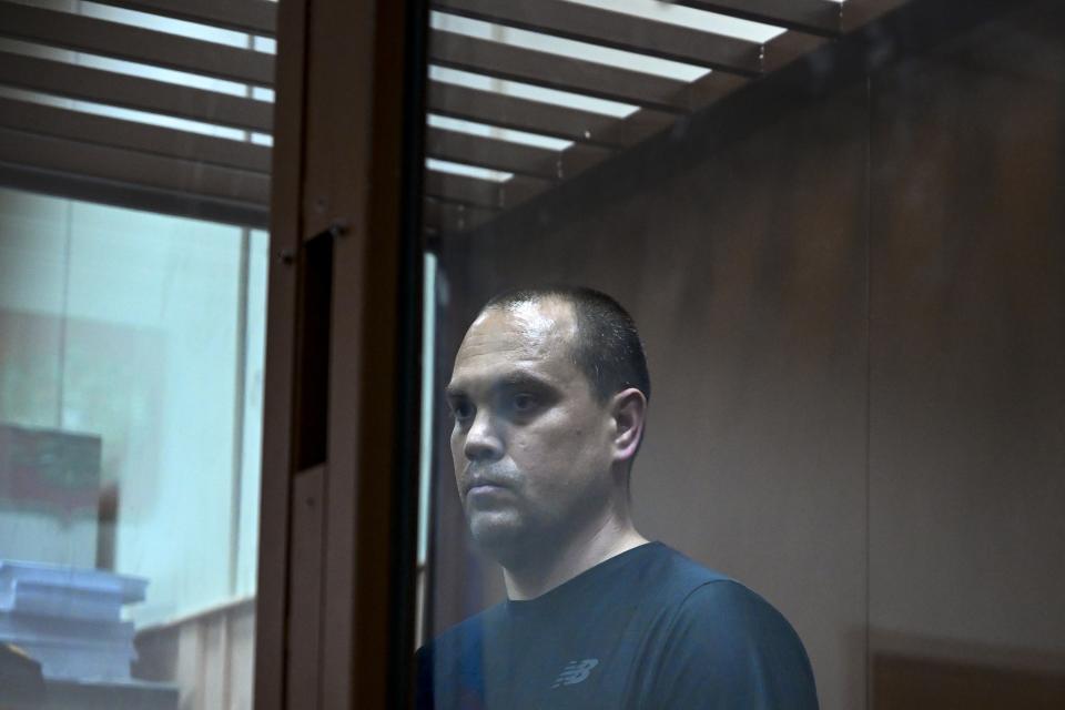 Opposition leader Alexei Navalny's lawyer Vadim Kobzev stands behind a glass in a cage in a courtroom in Moscow, Russia, Friday, Oct. 13, 2023. Russian authorities on Friday detained three lawyers representing imprisoned opposition leader Alexei Navalny after searching their homes, his allies said, a step that comes amid increasing pressure on the Kremlin's critics. (AP Photo/Dmitry Serebryakov)