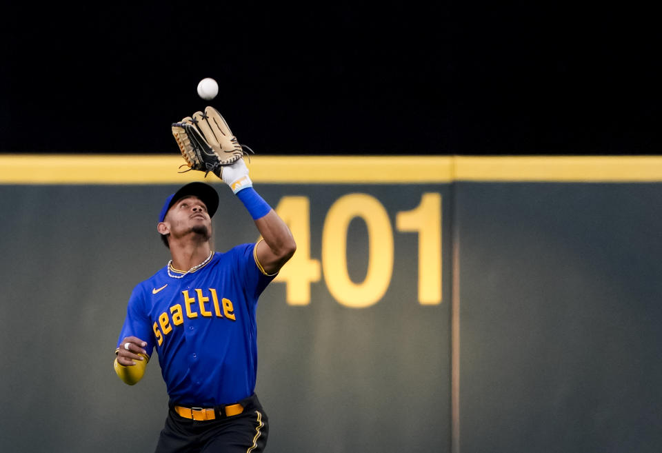 Seattle Mariners center fielder Julio Rodríguez catches a fly ball by Baltimore Orioles' Adley Rutschman during the third inning of a baseball game Friday, Aug. 11, 2023, in Seattle. (AP Photo/Lindsey Wasson)