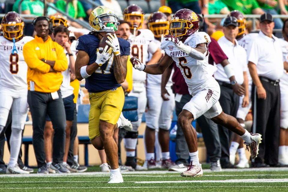 Notre Dame's Rico Flores Jr., left, makes a catch as Central Michigan's La'Vario Wiley (6) defends during the second half of an NCAA college football game on Saturday, Sept. 16, 2023, in South Bend, Ind. (AP Photo/Michael Caterina)