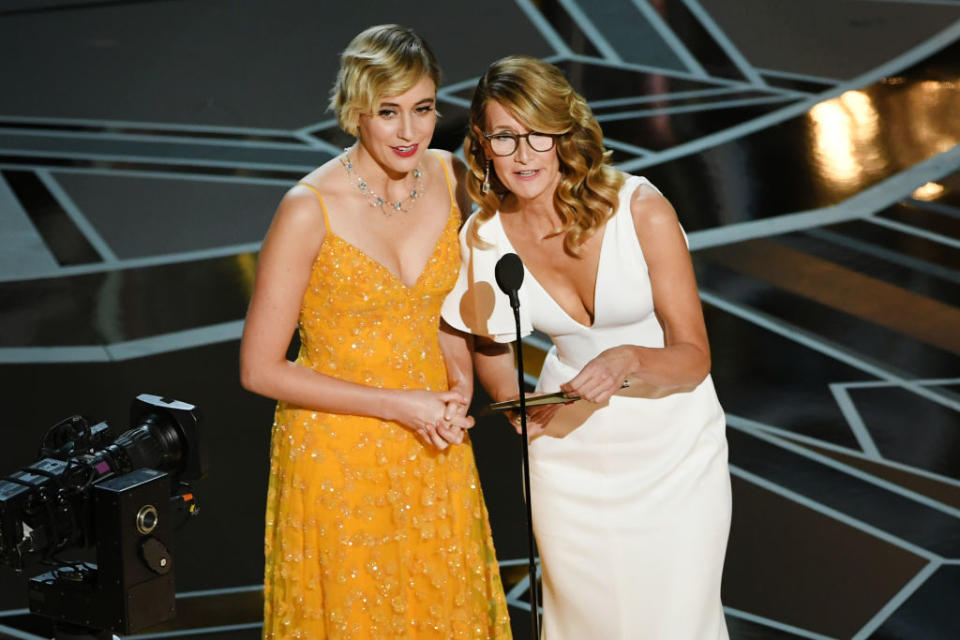 <p>Laura Dern wears tortoise frames with her white Calvin Klein by Appointment dress while presenting alongside Greta Gerwig at the 2018 Oscars. (Photo: Getty Images) </p>