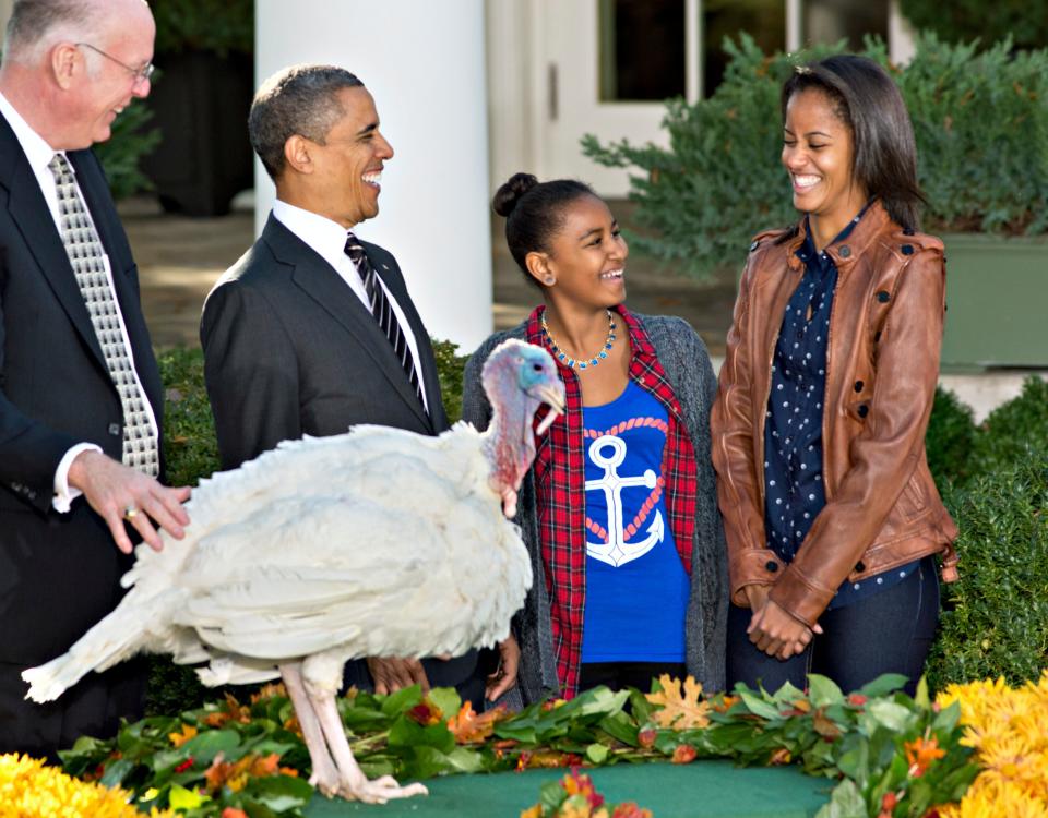 President Obama, with daughters Sasha and Malia, carries on the Thanksgiving tradition of saving a turkey from the dinner table with a presidential pardon at the White House on Nov. 21, 2012.