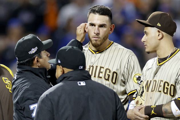 NEW YORK, NEW YORK - OCTOBER 09: Umpire Alfonso Marquez checks the ear of Joe Musgrove #44 of the San Diego Padres during the sixth inning against the New York Mets in game three of the National League Wild Card Series at Citi Field on October 09, 2022 in the Flushing neighborhood of the Queens borough of New York City. (Photo by Sarah Stier/Getty Images) (Photo: Sarah Stier via Getty Images)