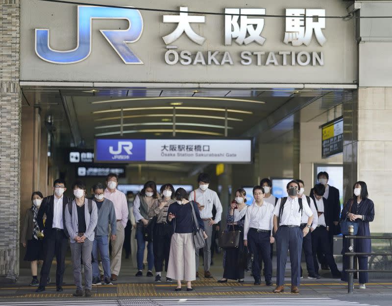 Commuters wearing protective masks head to work amid the coronavirus disease (COVID-19) outbreak in Osaka