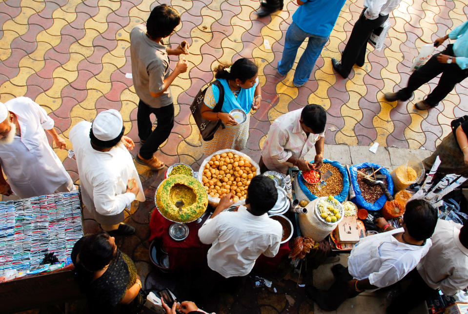 People eating snacks on the street in Mumbai.