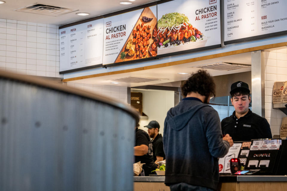 A customer pays for their food at a Chipotle Mexican Grill restaurant on April 26, 2023 in Austin, Texas.<p>Brandon Bell/Getty Images</p>