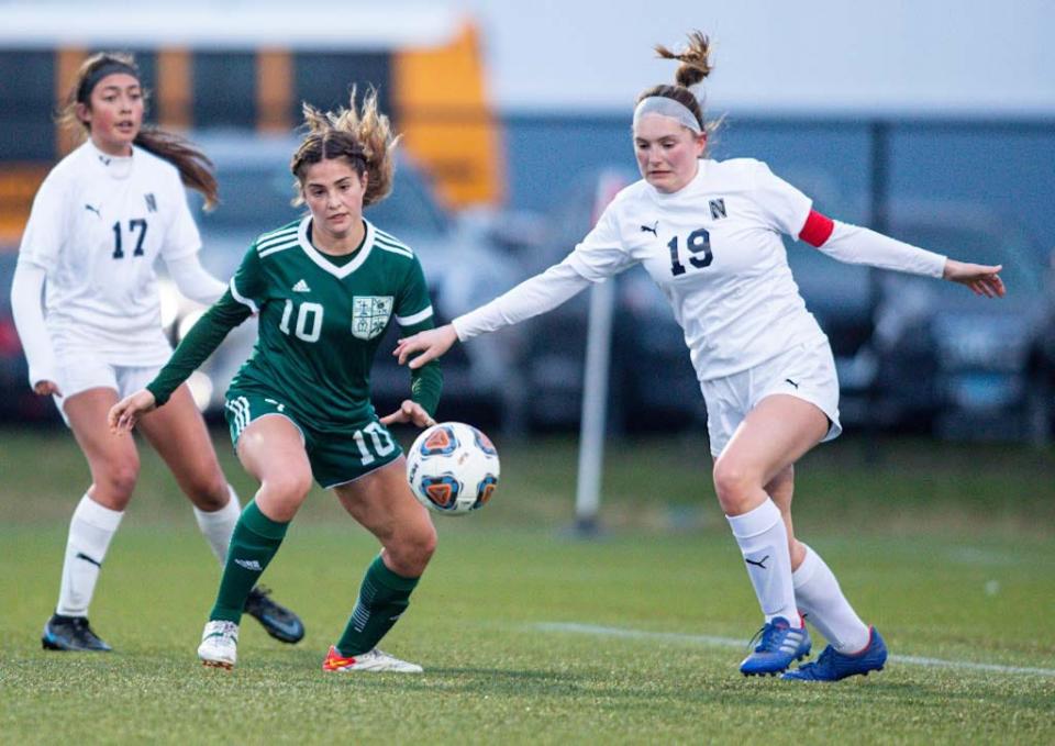 Boylan's Izze Fritz defends the ball against Belvidere North's Ada Parker at the Indoor Sports Center on Thursday, April 7, 2022, in Loves Park.