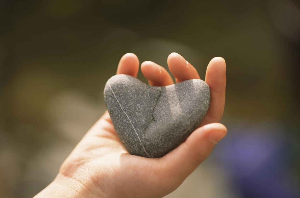 hand with heart shaped stone