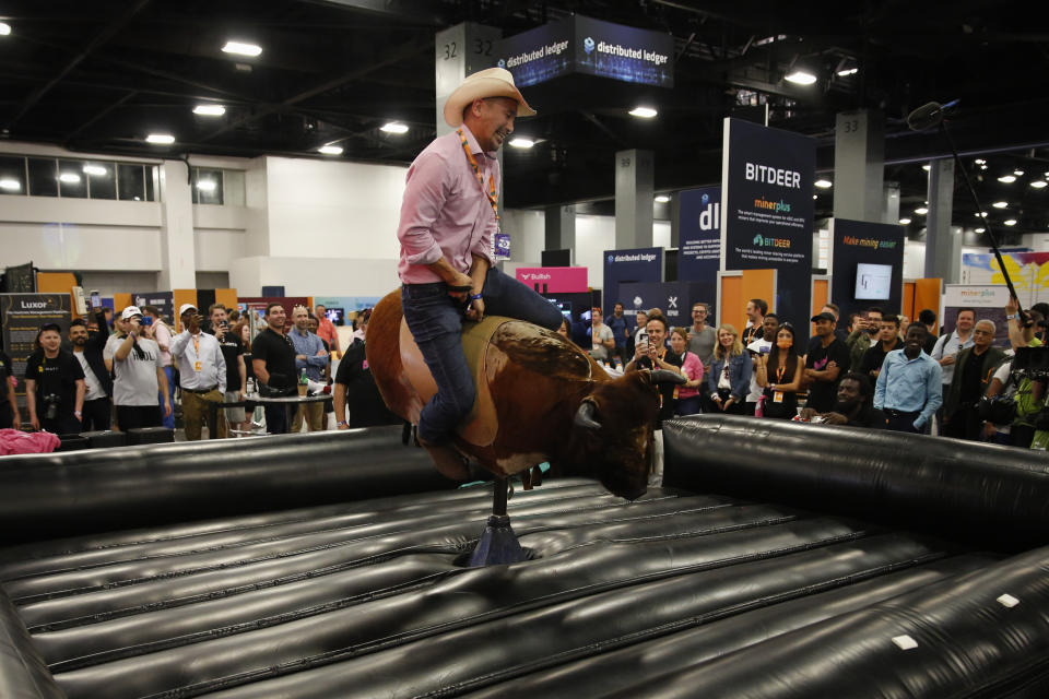 Jimmy Song, Bitcoin advocate, developer and author, rides a mechanical bull in the exhibition hall during the Bitcoin 2022 Conference at Miami Beach Convention Center on 7 April in Miami, Florida, US.