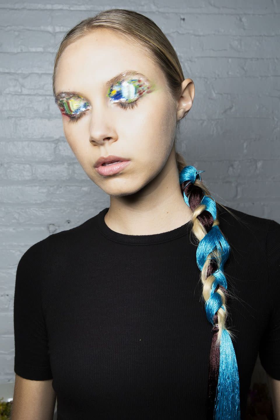 <p>More colorful extensions, this time braided through a low ponytail backstage at Lanyu.</p>