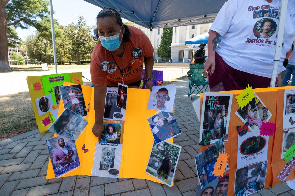 Del Paso Heights resident Telon Sanchez of Reaching Back to Our Youth shows photos of friends and family members killed by gun violence during the Organized Voices and Voices of Youth rally at the state Capitol on Thursday. The anti-gun violence rally was held to call for youth mentorship and community partnerships to prevent more shootings.