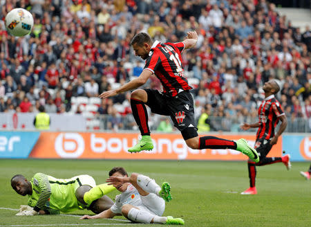 Football Soccer - Nice v Nancy - French Ligue 1 - Allianz Riviera Stadium, Nice, France 15/04/2017 - Nice's Mickael Le Bihan in action with Nancy's goalkeeper Guy Roland Ndy Assembe. REUTERS/Eric Gaillard