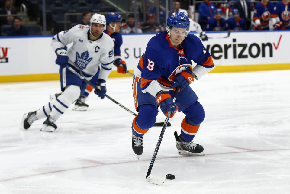 New York Islanders center Mathew Barzal (13) controls the puck with Toronto Maple Leafs center John Tavares trailing behind during the first period of an NHL hockey game, Monday, Dec. 11, 2023, in New York. (AP Photo/John Munson)