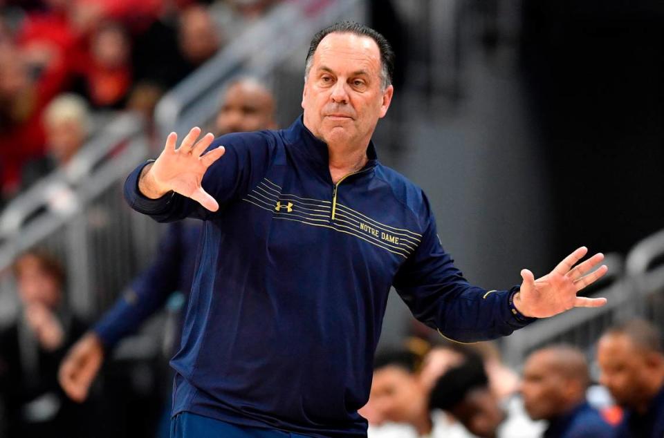 Notre Dame head coach Mike Brey sends instructions to his team during the second half of an NCAA college basketball game against Louisville in Louisville, Ky., Saturday, Jan. 22, 2022. Notre Dame won 82-70.