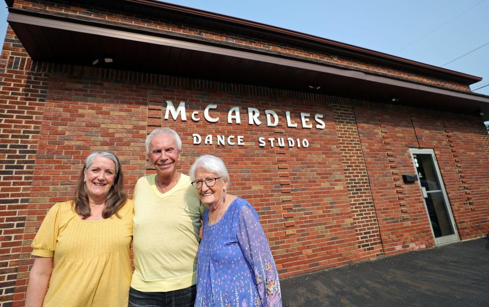 Don and Carolee McCardle, center and right, in front of their family’s dance studio with daughter Colleen McCardle-Contillo on Monday.