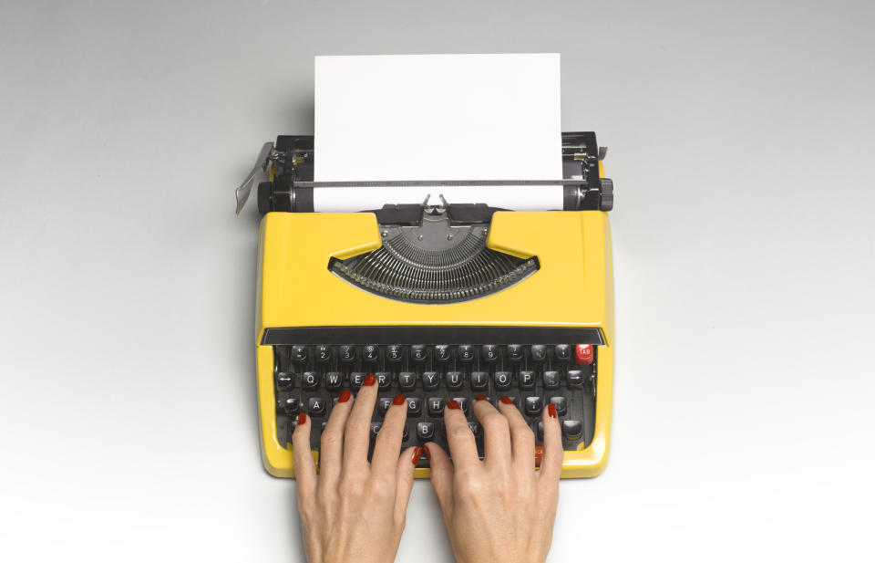 Someone typing on a typewriter