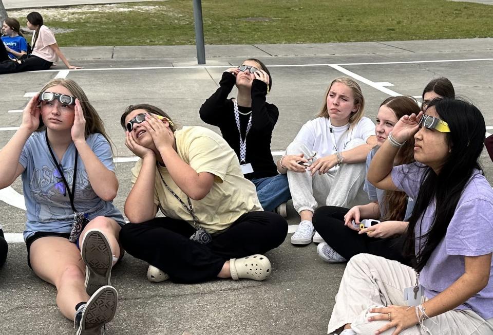 Eighth-grade students at Creekside Middle School in Port Orange view the solar eclipse through ISO 12312-2:2015-certified glasses on Monday, April 8, 2024.