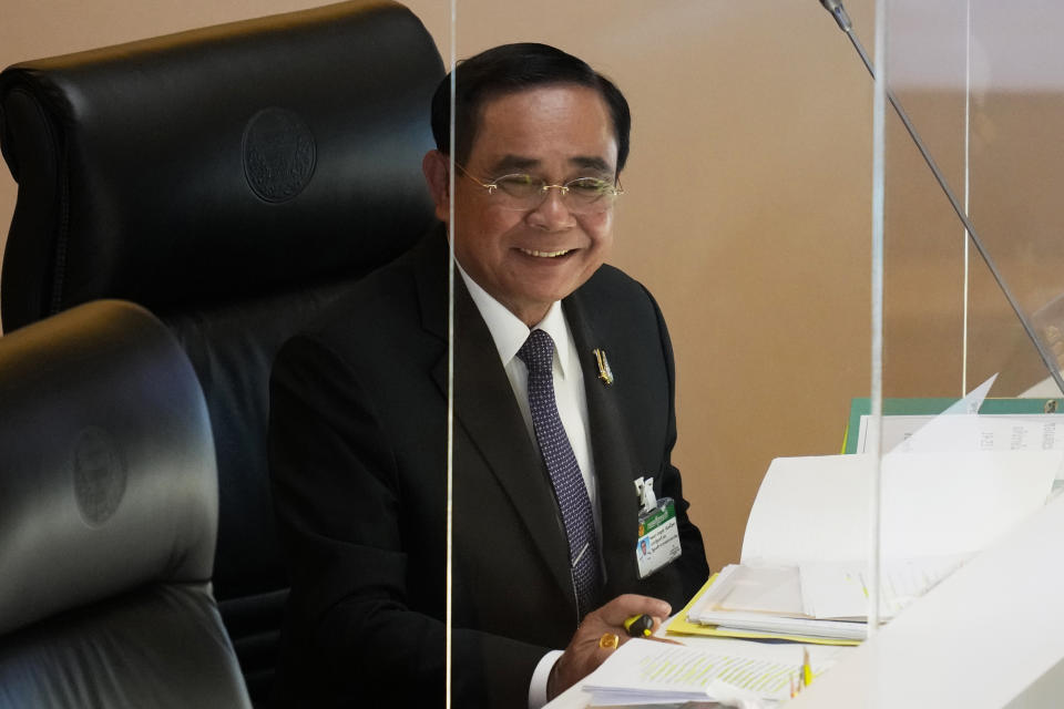 Thailand's Prime Minister Prayuth Chan-ocha smiles during a no-confidence debate at the Parliament in Bangkok, Thailand, Tuesday, July 19, 2022. Thailand's opposition parties on Tuesday began a no-confidence debate targeting Prayuth and ten of his Cabinet members, who face accusations of corruption and economic mismanagement. (AP Photo/Sakchai Lalit)