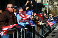 <p>Spectators wave flags as members of the armed forces march during the Veterans Day parade on Fifth Avenue in New York on Nov. 11, 2017. (Photo: Gordon Donovan/Yahoo News) </p>