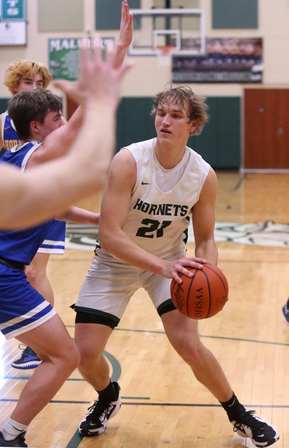 Michael Minor, 21, of Malvern looks for an opening during their game against East Canton at Malvern on Friday, Jan. 28, 2022.