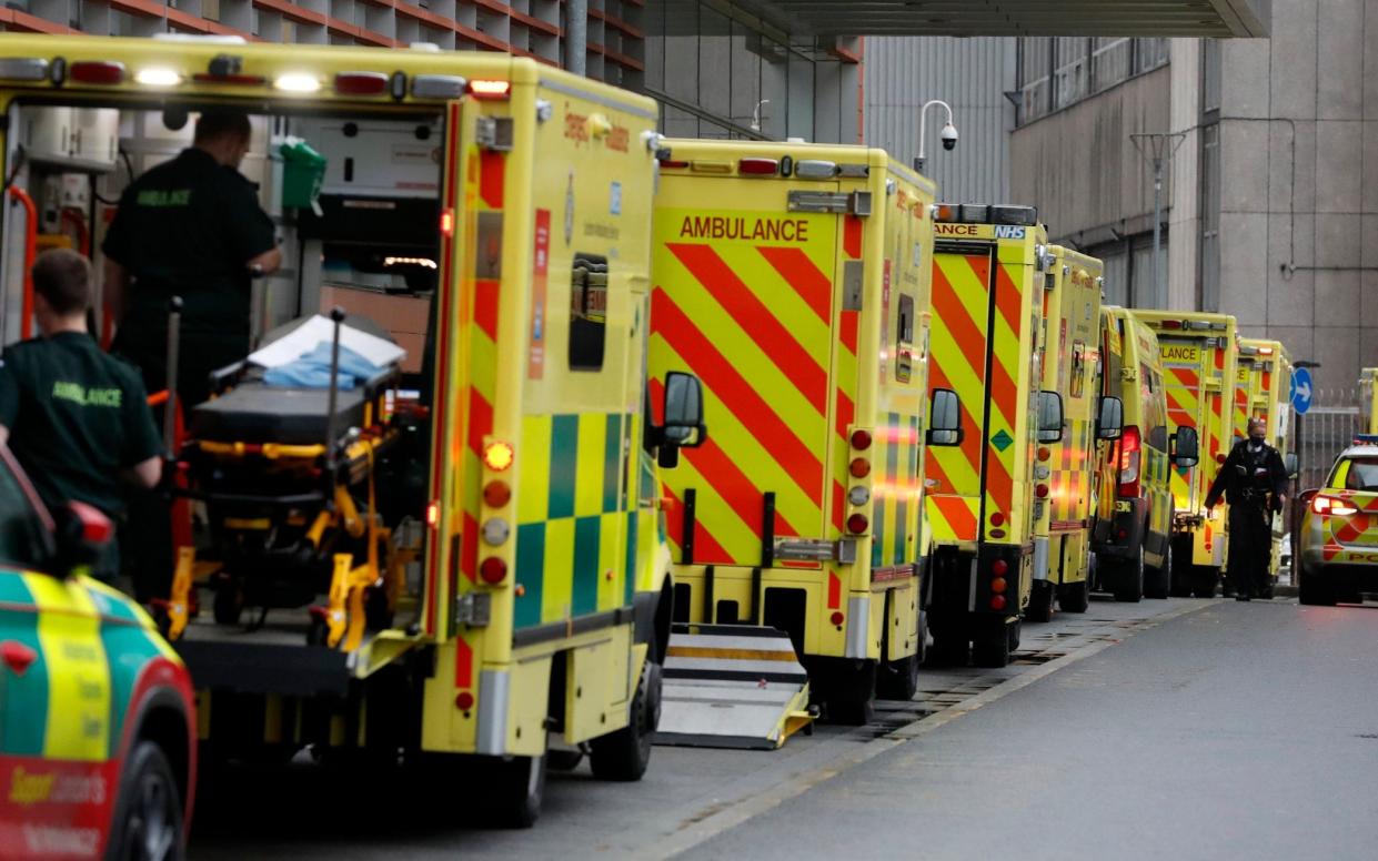 Ambulances queue at the Royal London Hospital in London - Alastair Grant/AP Photo