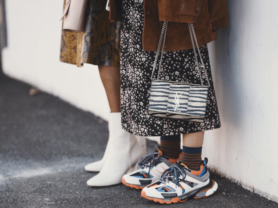 Two people wearing colorful sneakers and mixed prints