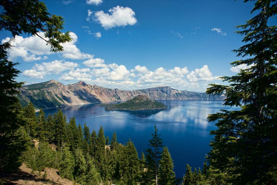 <p>The main attraction at <a href="https://www.nationalparks.org/explore-parks/crater-lake-national-park" rel="nofollow noopener" target="_blank" data-ylk="slk:Crater Lake;elm:context_link;itc:0;sec:content-canvas" class="link ">Crater Lake</a> is, well, the lake: it's the deepest one in the country and the seventh deepest lake in the world. It's inside a caldera (a volcanic basin) and was created when a large eruption caused 12,000 foot high Mount Mazama to collapse over 7,000 years ago. It's also one of the clearest lakes in the world and surrounded by lush evergreens, mountains, and wide open sky. </p>