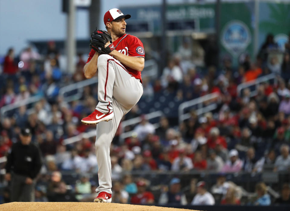 Washington Nationals starting pitcher Max Scherzer winds up in the first inning of a spring training baseball game against the Houston Astros in West Palm Beach, Fla., Saturday, Feb. 22, 2020. (Karen Warren/Houston Chronicle via AP)