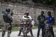 A police officer patrols a street during an anti-gang operation in Croix-des-Missions, north of Port-au-Prince, Haiti, Thursday, April 28, 2022. Haiti's understaffed and under-resourced police department is roughly made up of 11,000 officers for a country of more than 11 million people. (AP Photo/Odelyn Joseph)